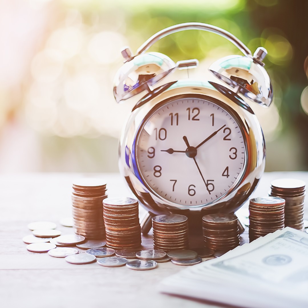 a clock with money around it